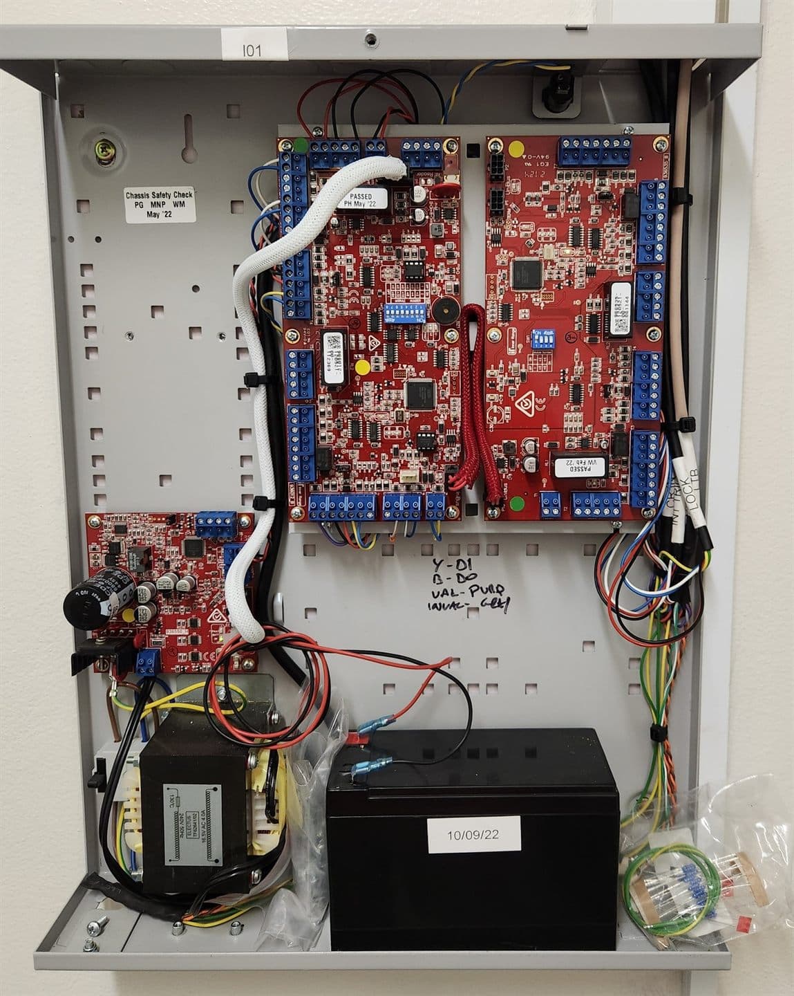 Intruder-alarm and access controller panel wired into a metal enclosure with backup battery