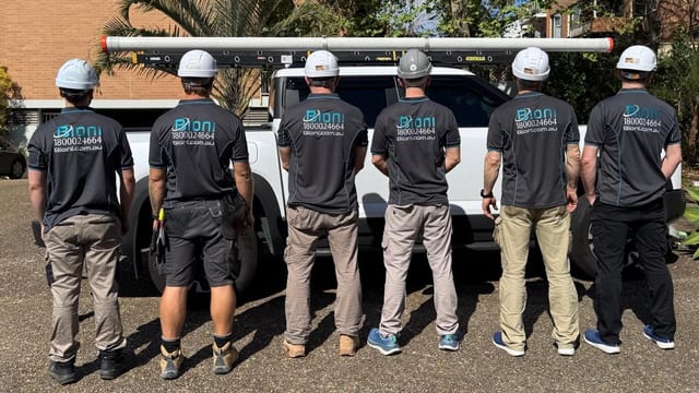 The Bioni crew in branded uniforms beside the company ute on a Sydney job